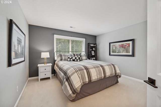 bedroom featuring light carpet