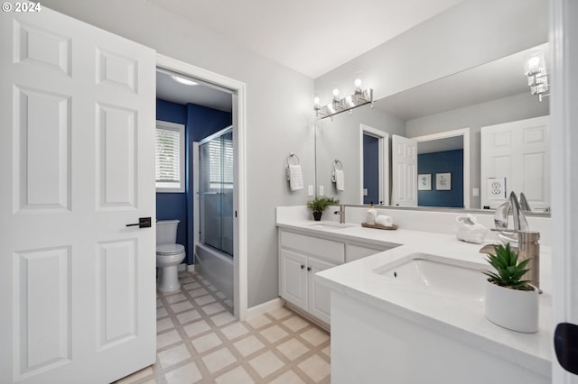 full bathroom with vanity, toilet, and enclosed tub / shower combo