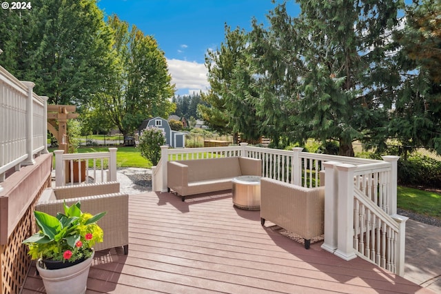 deck with an outdoor living space and a storage shed