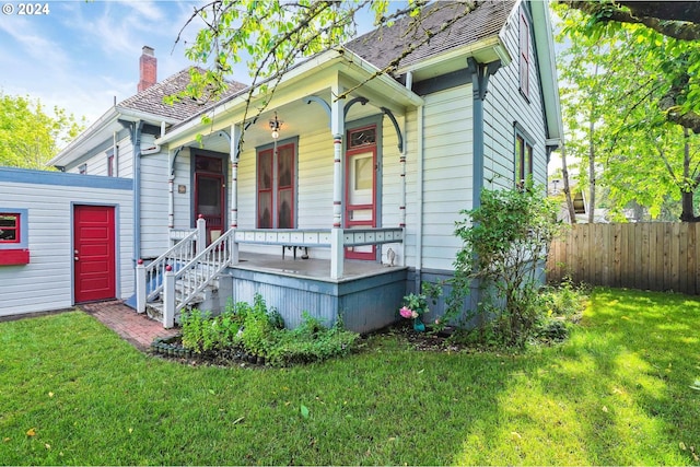 view of front of property with covered porch and a front yard