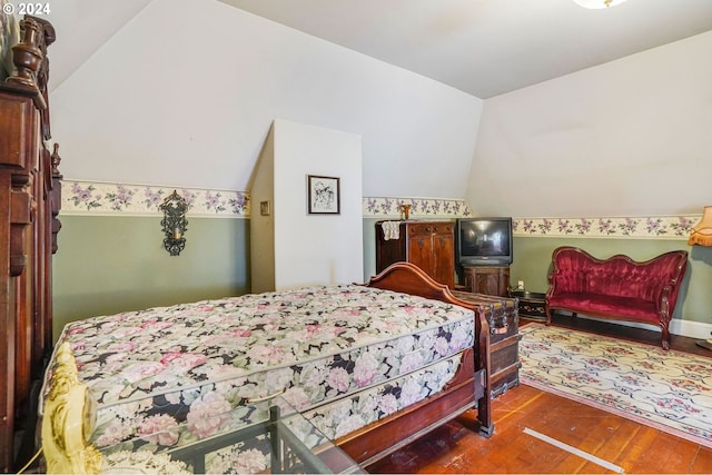 bedroom featuring wood-type flooring and vaulted ceiling