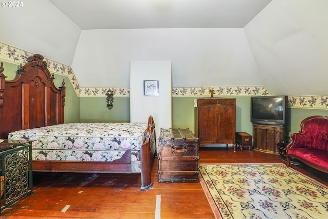 bedroom featuring vaulted ceiling and dark hardwood / wood-style floors