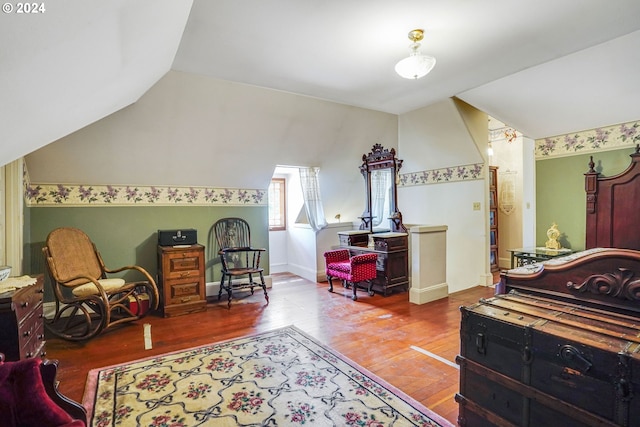 bedroom featuring vaulted ceiling and hardwood / wood-style floors