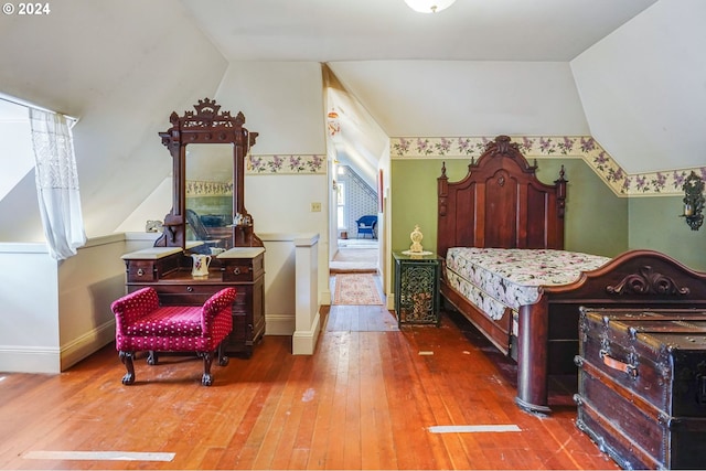 bedroom featuring lofted ceiling and hardwood / wood-style floors