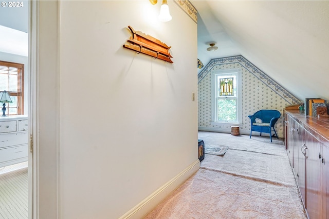 bonus room featuring light colored carpet and vaulted ceiling