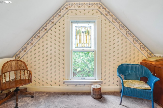 living area featuring carpet and lofted ceiling