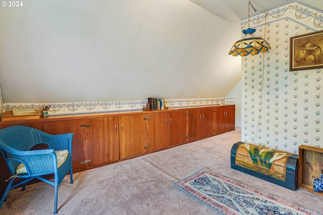 living area featuring vaulted ceiling and light carpet