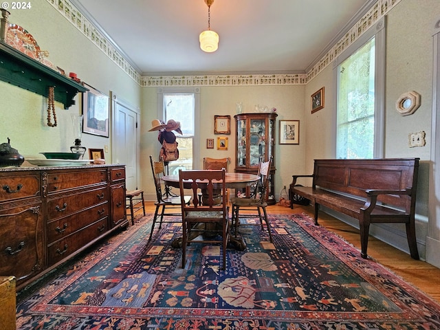 dining room with crown molding and hardwood / wood-style flooring