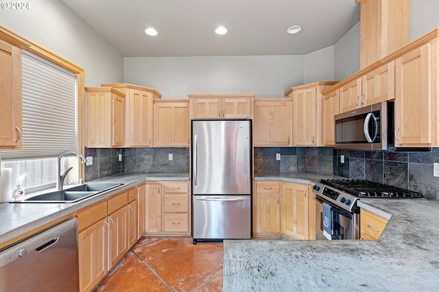 kitchen with light brown cabinets, sink, stainless steel appliances, and tasteful backsplash