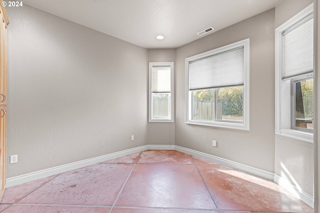 unfurnished room featuring tile patterned flooring