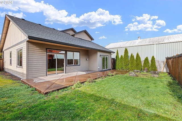 back of house featuring a yard and a patio