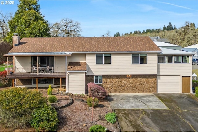 10685 Oak Dr SE, Salem, OR 97306 - rear view of house with driveway, a chimney, a garage, and roof with shingles