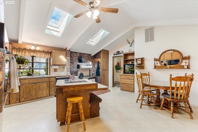 10685 Oak Dr SE, Salem, OR 97306 - kitchen with visible vents, brown cabinetry, a kitchen island, and light floors