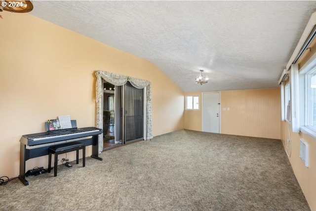 10685 Oak Dr SE, Salem, OR 97306 - sitting room with carpet flooring, a textured ceiling, a chandelier, and lofted ceiling