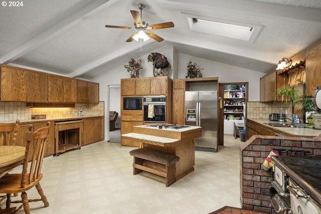 10685 Oak Dr SE, Salem, OR 97306 - kitchen with tile counters, brown cabinets, light floors, black appliances, and vaulted ceiling