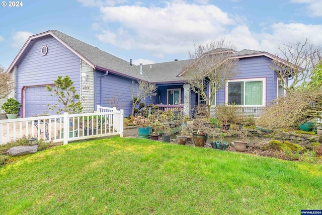 view of front of property with a garage and a front lawn