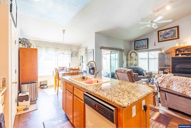 kitchen with dishwasher, an island with sink, vaulted ceiling, and sink