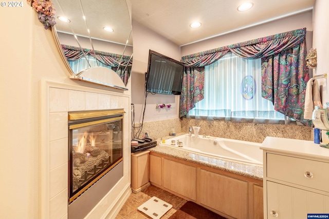 bathroom with a tub and a tiled fireplace