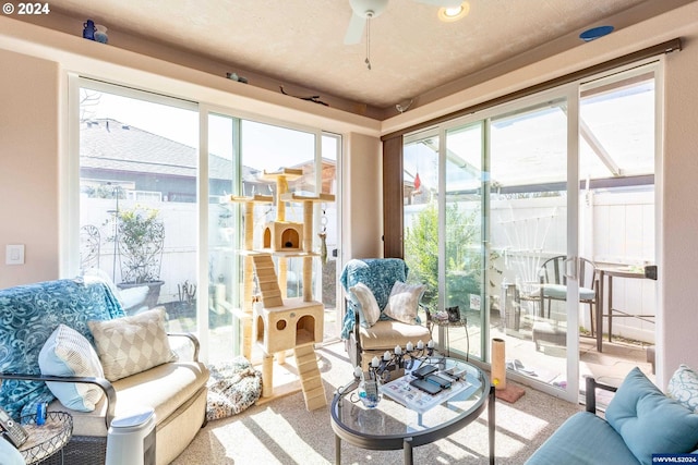 sunroom / solarium with a wealth of natural light and ceiling fan