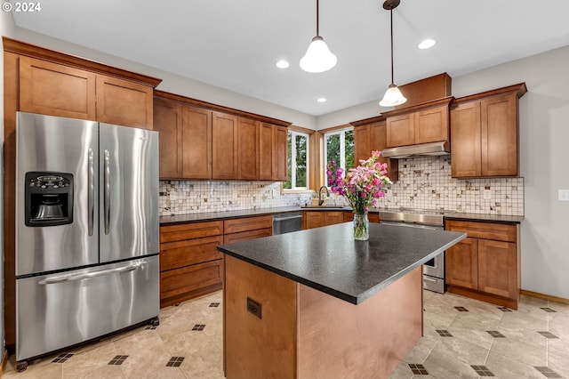 kitchen with sink, a kitchen island, pendant lighting, stainless steel appliances, and decorative backsplash