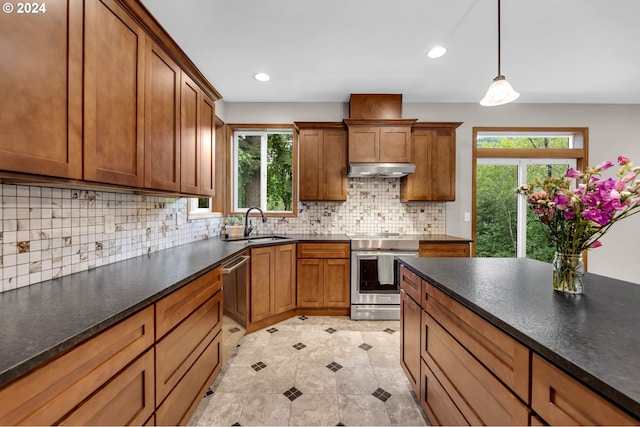 kitchen featuring appliances with stainless steel finishes, sink, decorative backsplash, hanging light fixtures, and light tile patterned floors