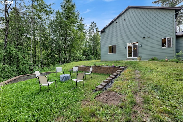 rear view of property featuring a yard