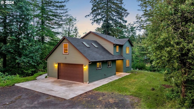 view of front of home featuring a garage and a lawn