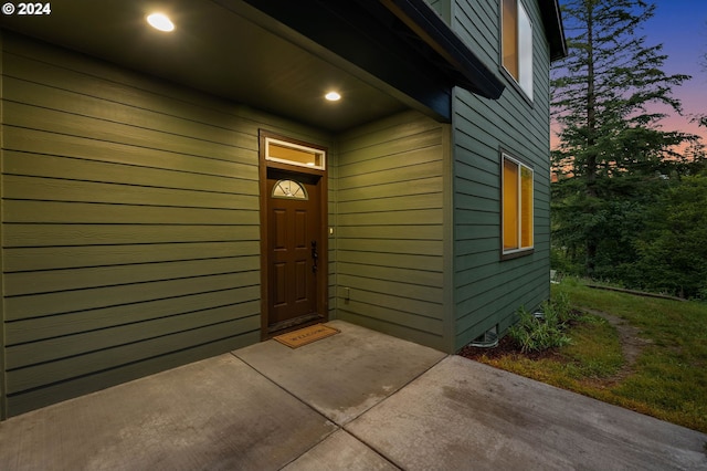 view of exterior entry at dusk