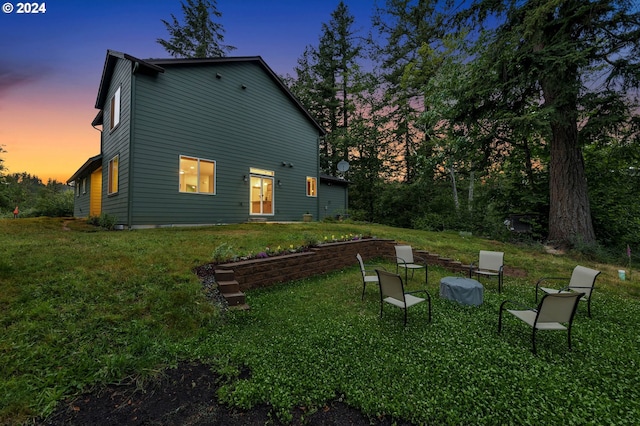 back house at dusk with a yard