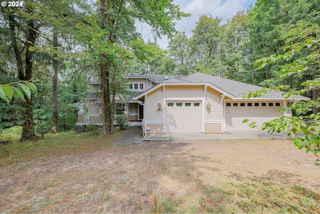 view of front facade featuring a garage and dirt driveway