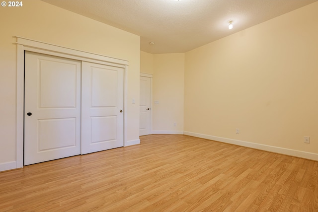 carpeted empty room featuring a textured ceiling