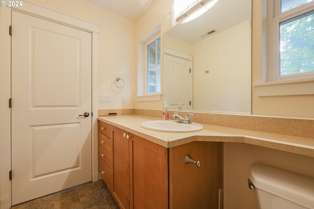 bathroom with tile patterned flooring, toilet, and vanity