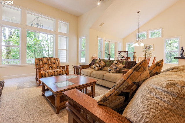 dining space with light hardwood / wood-style flooring, a wealth of natural light, a chandelier, and vaulted ceiling