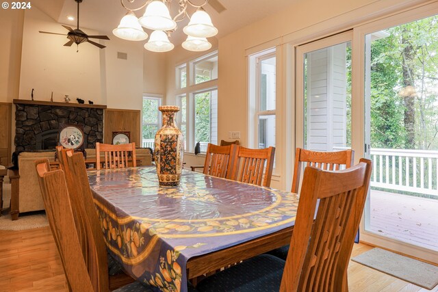 kitchen with light wood-type flooring, appliances with stainless steel finishes, island exhaust hood, and decorative backsplash