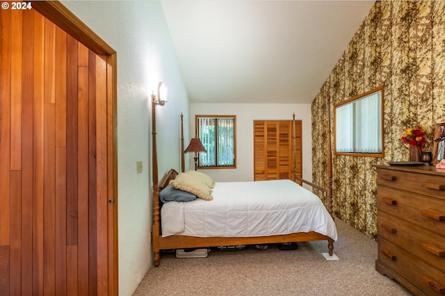 bedroom with carpet floors and vaulted ceiling