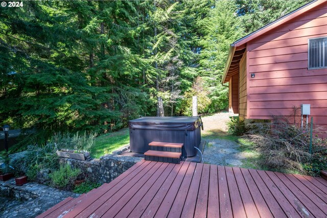 wooden deck featuring a hot tub