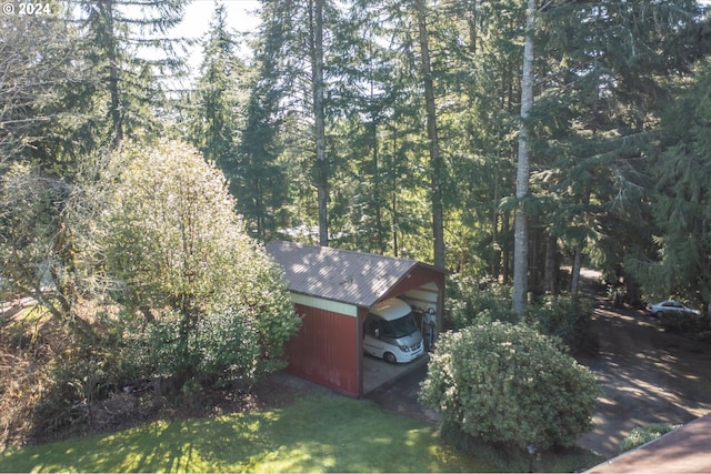 exterior space with a lawn and a carport