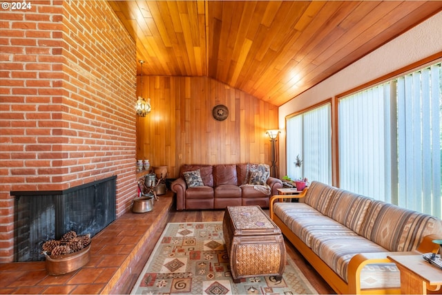 living room featuring vaulted ceiling, a fireplace, wood walls, hardwood / wood-style flooring, and wooden ceiling