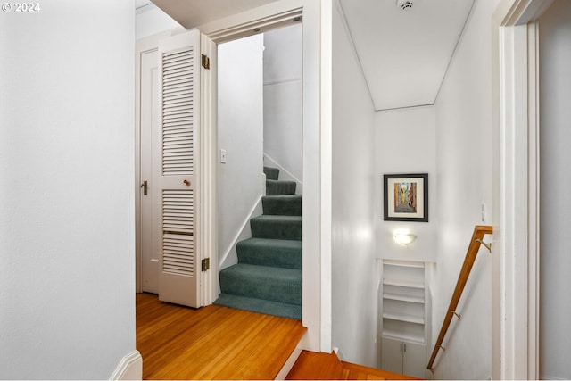 stairs featuring hardwood / wood-style floors