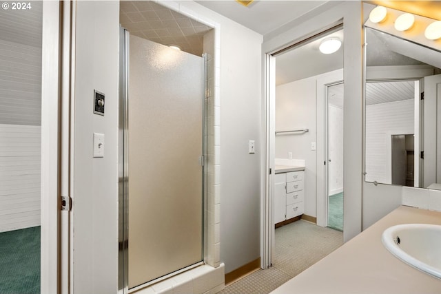 bathroom with vanity and a shower with door