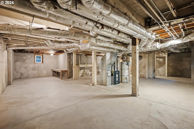 basement with water heater and heating unit