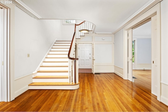 interior space featuring ornamental molding and wood-type flooring