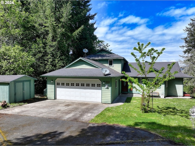 view of front of home with a storage shed, a front yard, and a garage