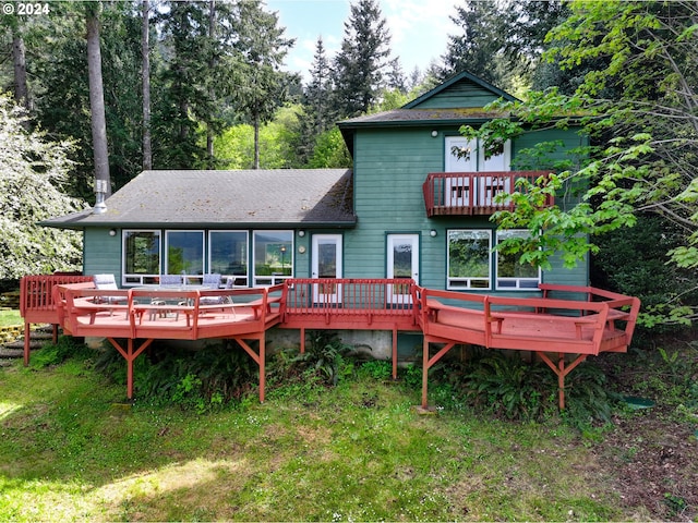 rear view of property featuring a wooden deck