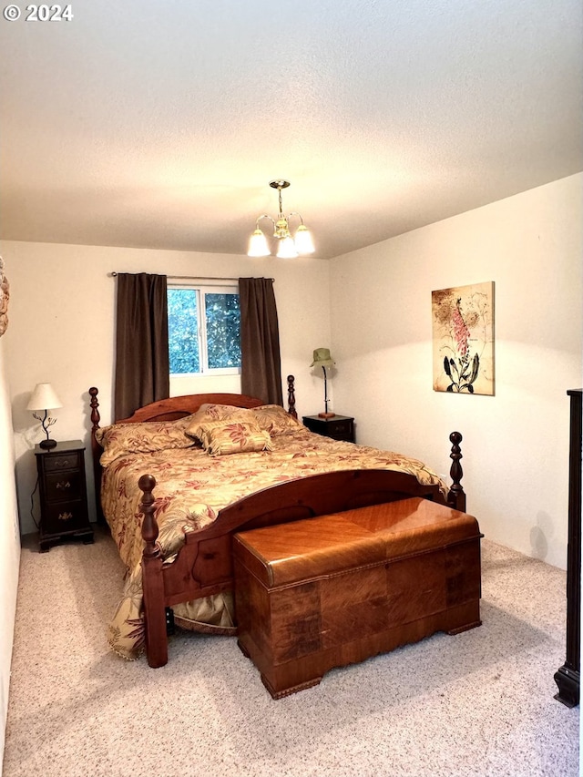 bedroom with carpet flooring, a chandelier, and a textured ceiling