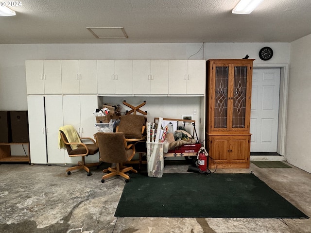 miscellaneous room featuring concrete flooring and a textured ceiling