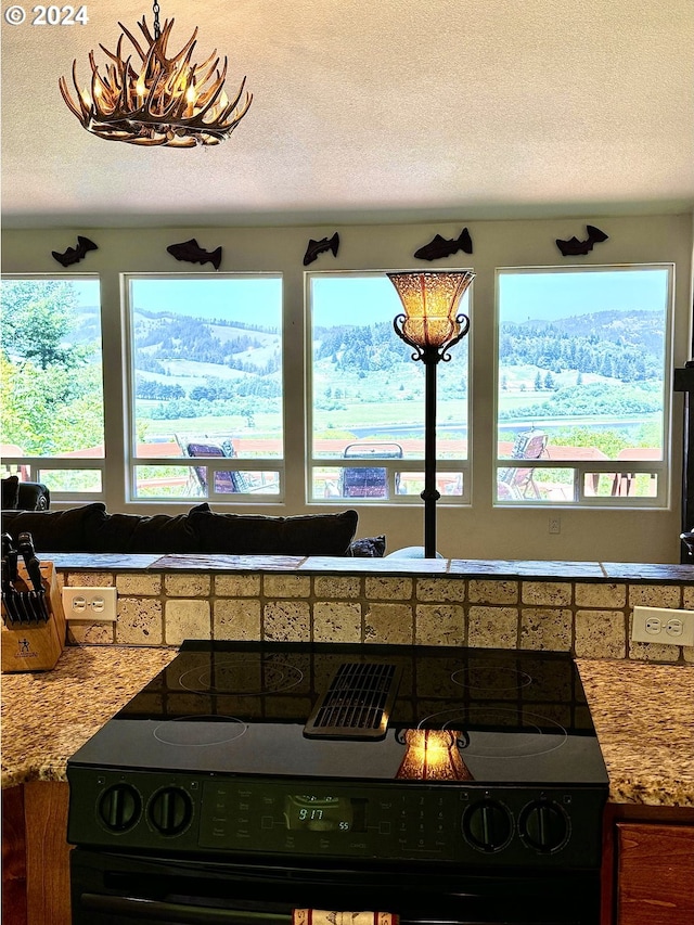 kitchen with black / electric stove and a textured ceiling