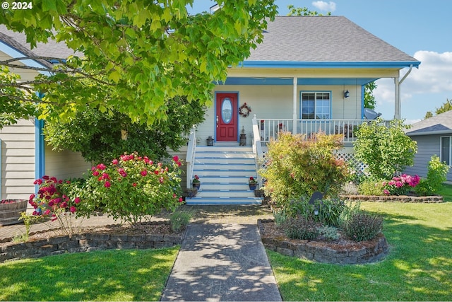 bungalow-style home with a porch and a front yard