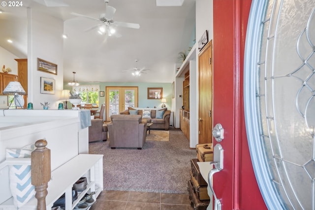 living room with dark colored carpet, lofted ceiling, and ceiling fan