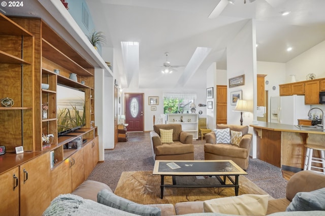 carpeted living room featuring ceiling fan, high vaulted ceiling, and sink